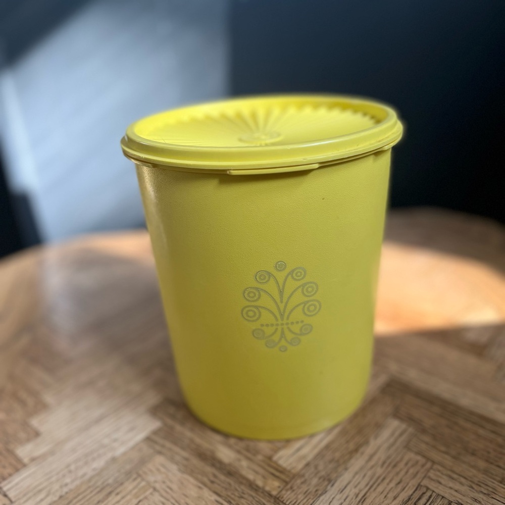 Vintage Tupperware canister with sunburst lid in daffodil yellow; large
